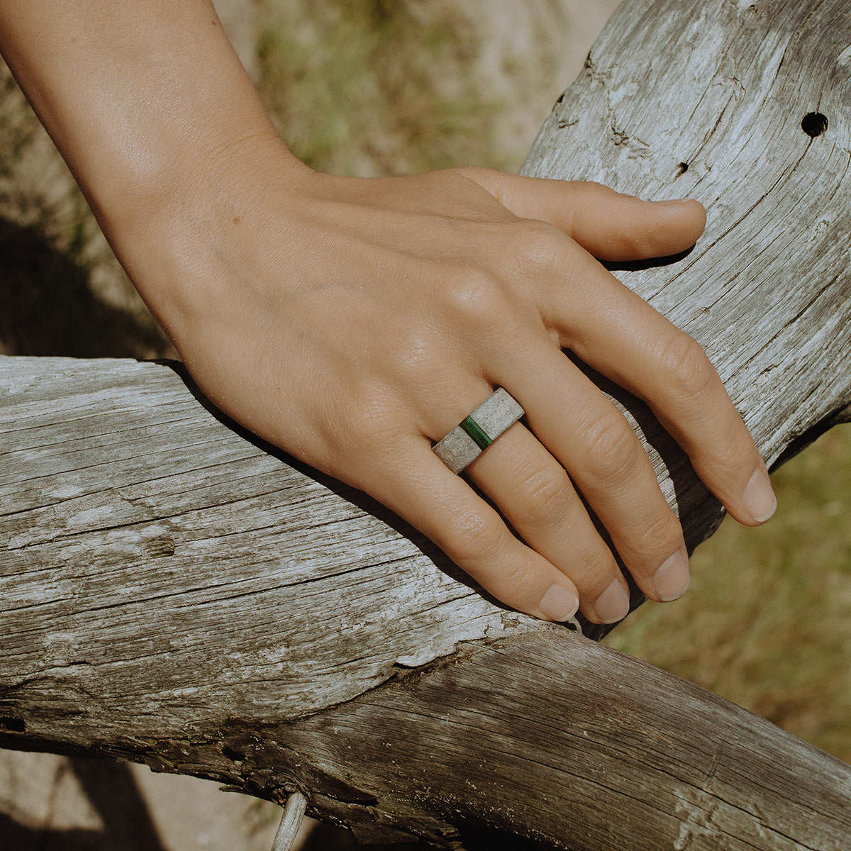 Close-up of a hand wearing a one-of-a-kind ring composed of tantalum and rough tourmaline by ASR JWLS.