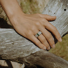Close-up of a hand wearing a one-of-a-kind ring composed of tantalum and rough tourmaline by ASR JWLS.