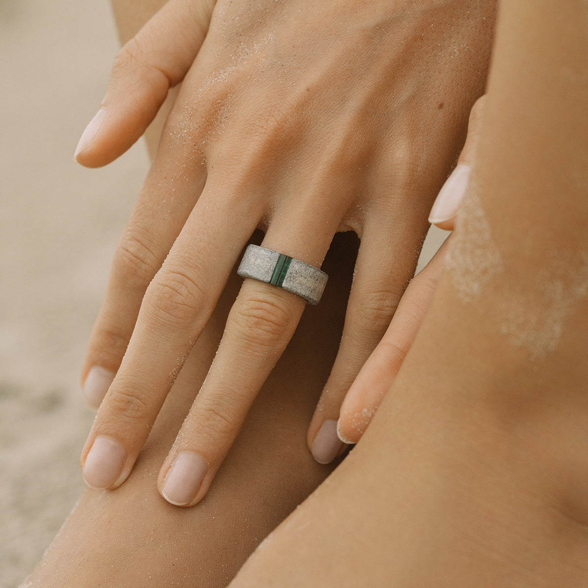 Close-up of a hand wearing a one-of-a-kind ring composed of tantalum and rough tourmaline by ASR JWLS.