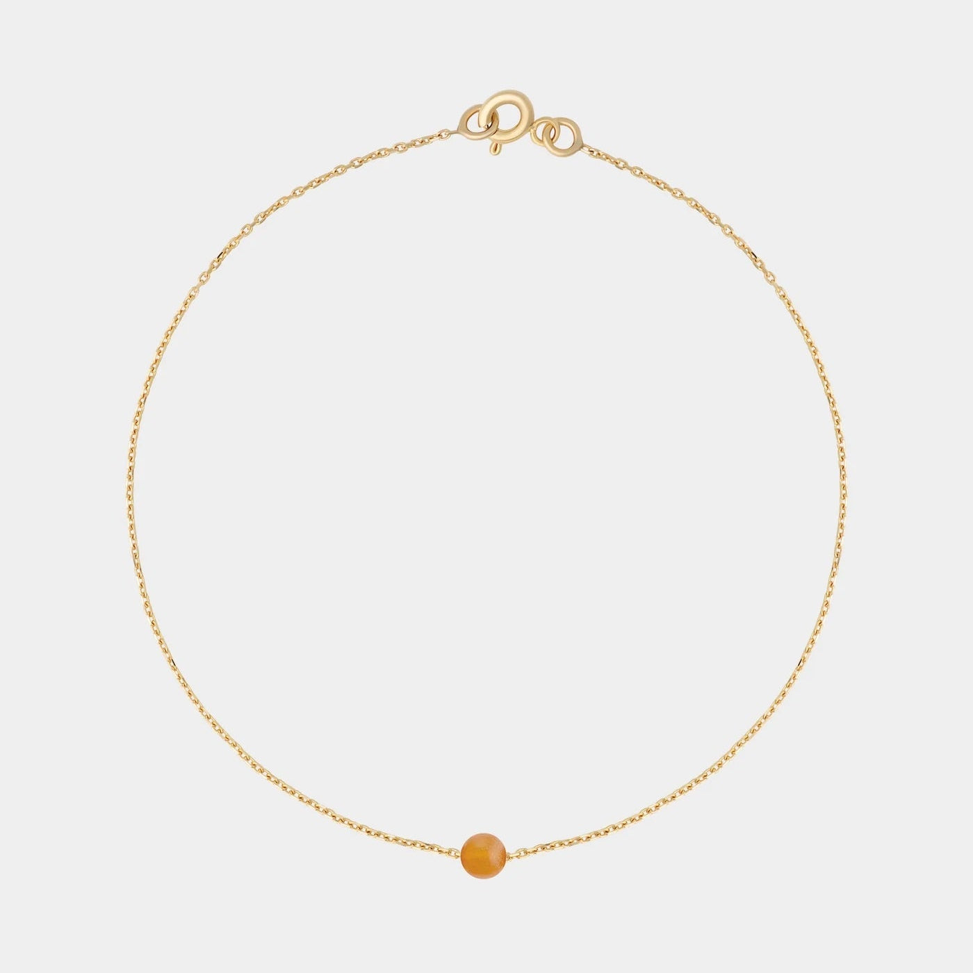 Gold bracelet with small Baltic amber by Adele Notes.