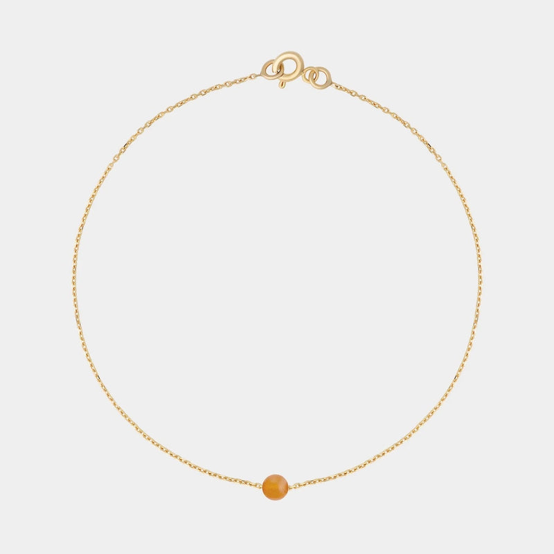 Gold bracelet with small Baltic amber by Adele Notes.