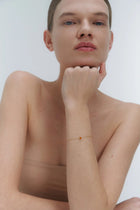 Gold bracelet with small Baltic amber by Adele Notes.