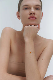 Gold bracelet with small Baltic amber by Adele Notes.