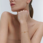 Gold bracelet with small Baltic amber by Adele Notes.