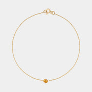 Gold bracelet with small Baltic amber by Adele Notes.
