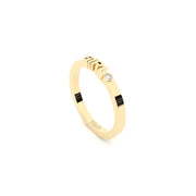 A solid yellow gold ring with the finest quality laboratory made diamond, featuring the inscription 'GIRL' on it.
