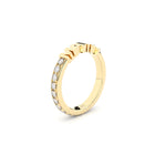 Gold ring with embedded diamonds on a white background