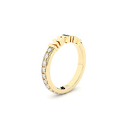 Gold ring with embedded diamonds on a white background