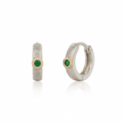 Pair of hoop earrings with emeralds on a white background