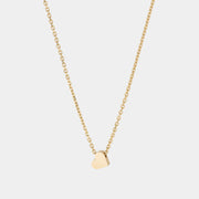 A yellow gold necklace with a heart-shaped pendant.
