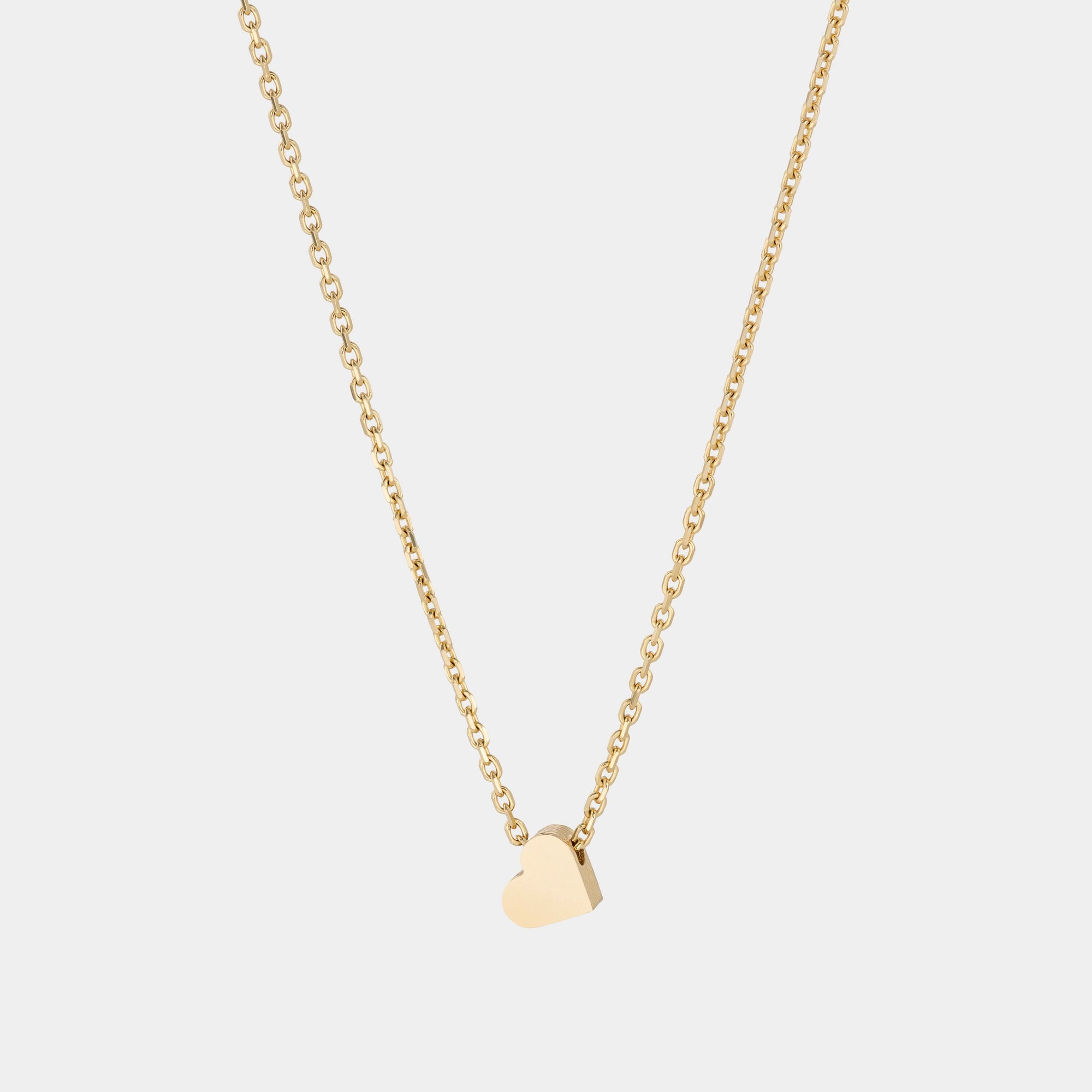 A yellow gold necklace with a heart-shaped pendant.