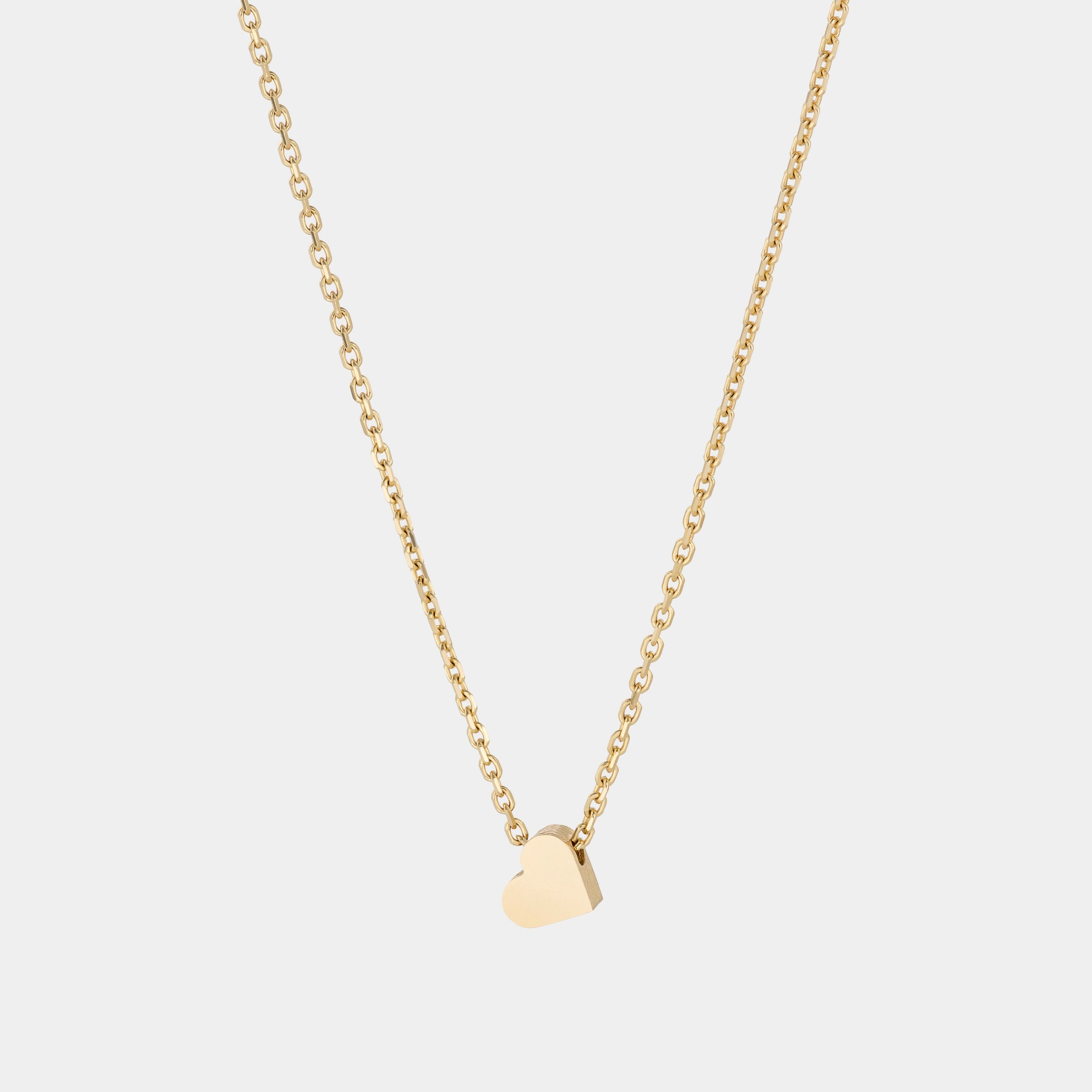 A yellow gold necklace with a heart-shaped pendant.