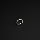 A polished silver-toned metal open-ended ring ear cuff, shown on a plain black background.