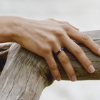 Hand wearing a one-of-a-kind ring composed of niobium and a white diamond by ASR JWLS.