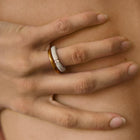 Hand wearing one-of-a-kind ring composed of tantalum and a white diamond by ASR JWLS.