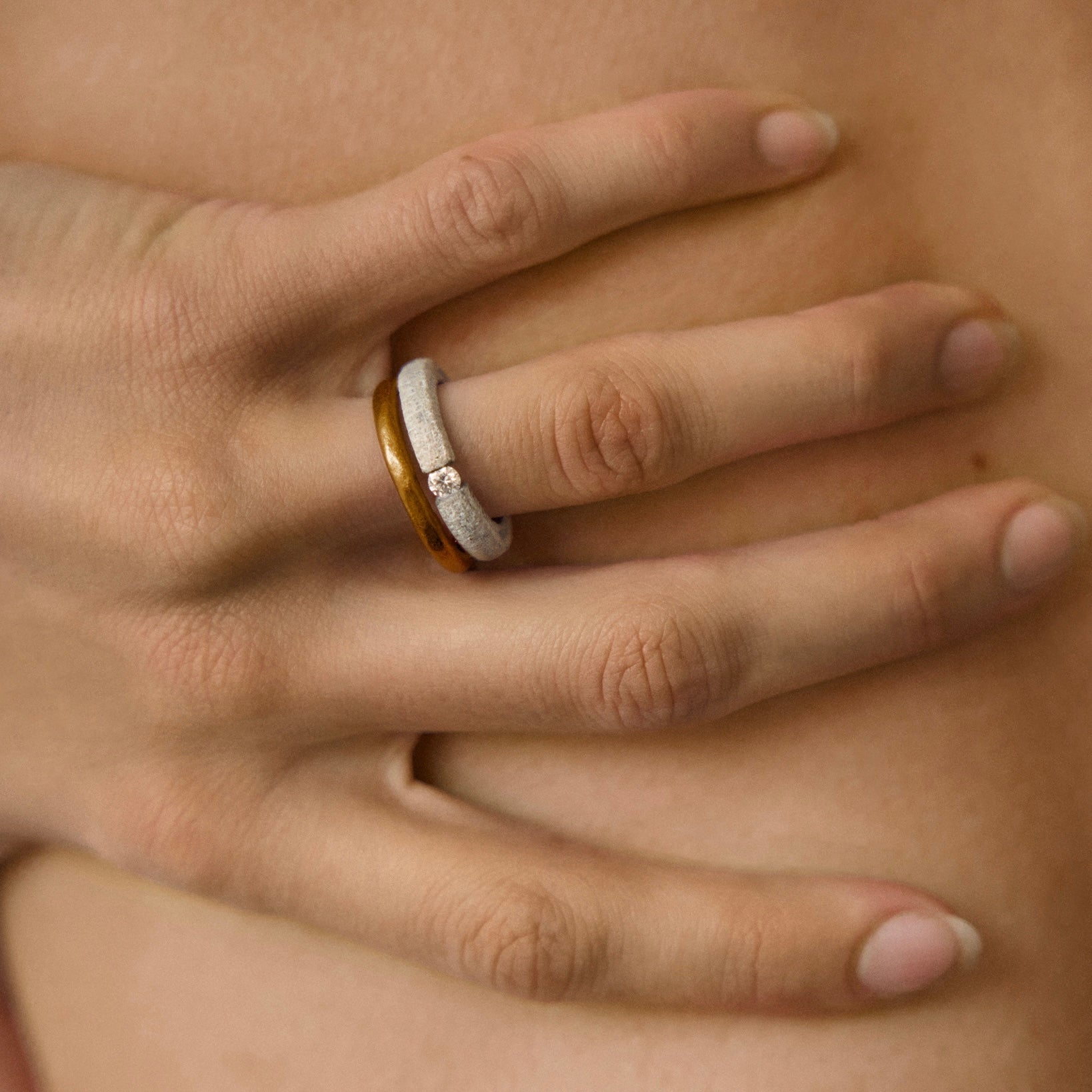 Hand wearing one-of-a-kind ring composed of tantalum and a white diamond by ASR JWLS.