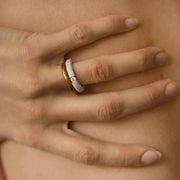 Hand wearing one-of-a-kind ring composed of tantalum and a white diamond by ASR JWLS.