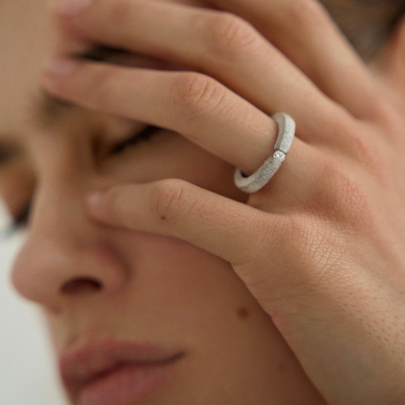 Woman wearing one-of-a-kind ring composed of tantalum and a white diamond by ASR JWLS.