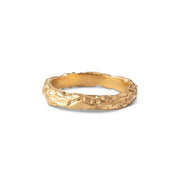A gold-plated silver ring with a textured band, viewed from a side angle against a white background.