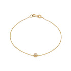 A 14k yellow gold bracelet with a white diamond accent, featuring a simple chain design.