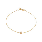A 14k yellow gold bracelet with a white diamond accent, featuring a simple chain design.