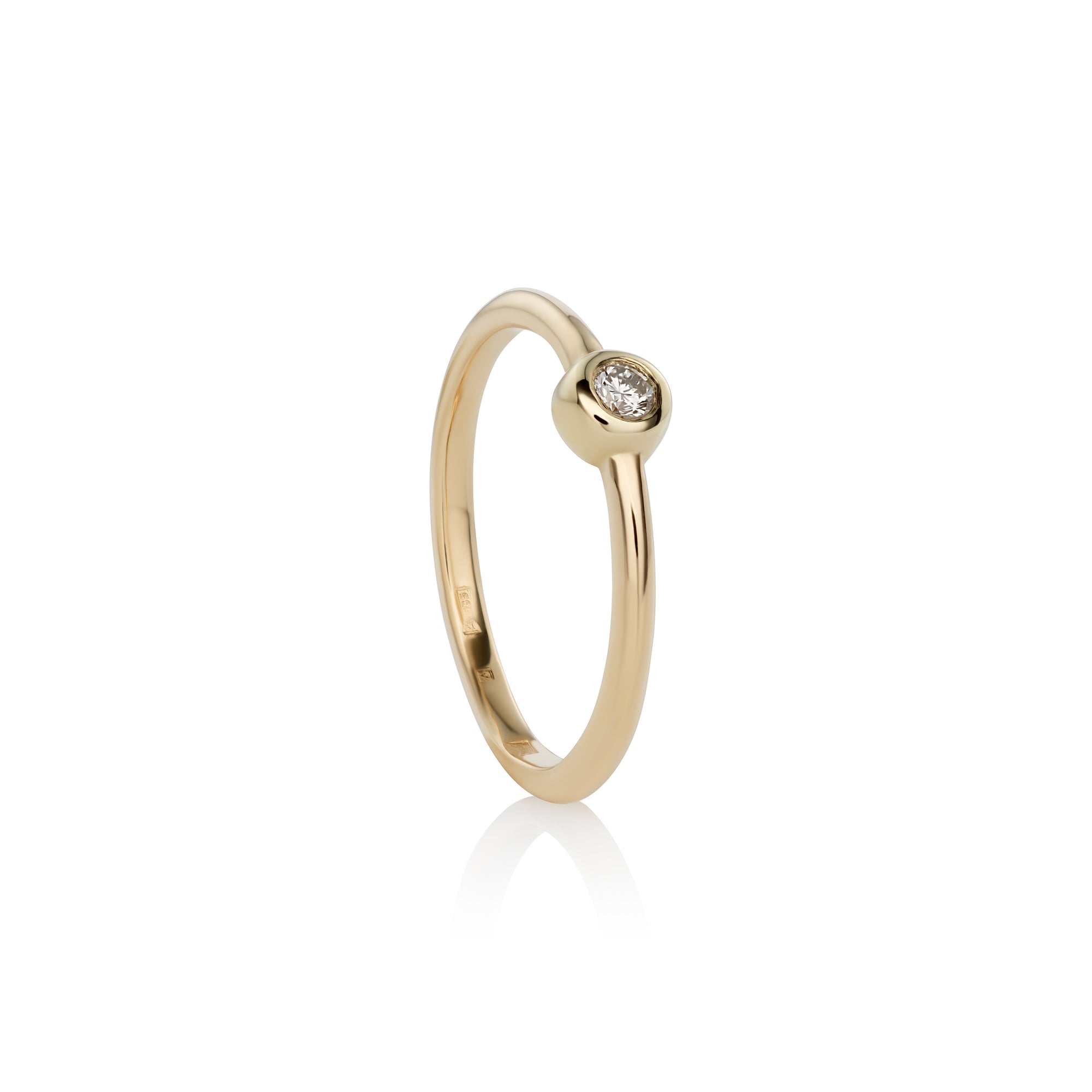 A 14k yellow gold ring with a single white diamond set in a gold band, with a polished finish.