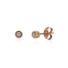 A pair of 14k rose gold basic stud earrings with white diamonds, displayed against a white background.