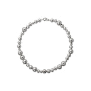 A necklace with varying sized silver beads strung together on a chain.