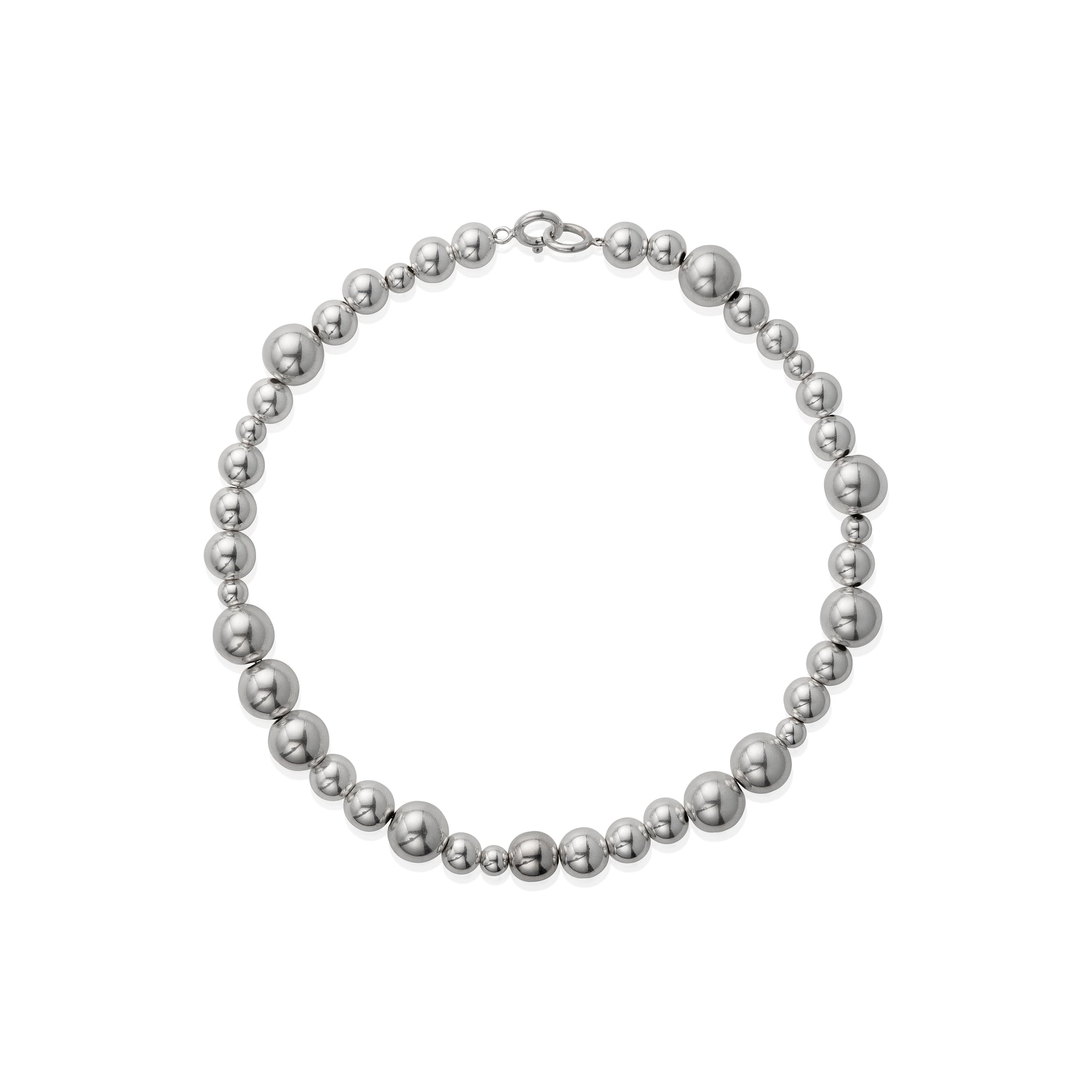 A necklace with varying sized silver beads strung together on a chain.