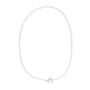 Delicate freshwater pearl necklace featuring organically shaped pearls and a minimalist silver clasp against white background.