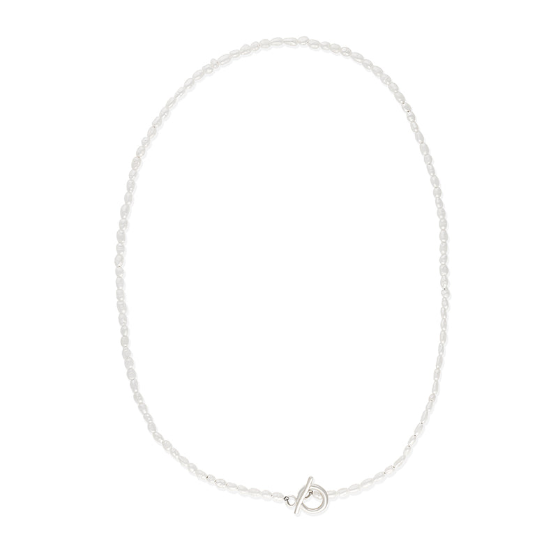 Delicate freshwater pearl necklace featuring organically shaped pearls and a minimalist silver clasp against white background.