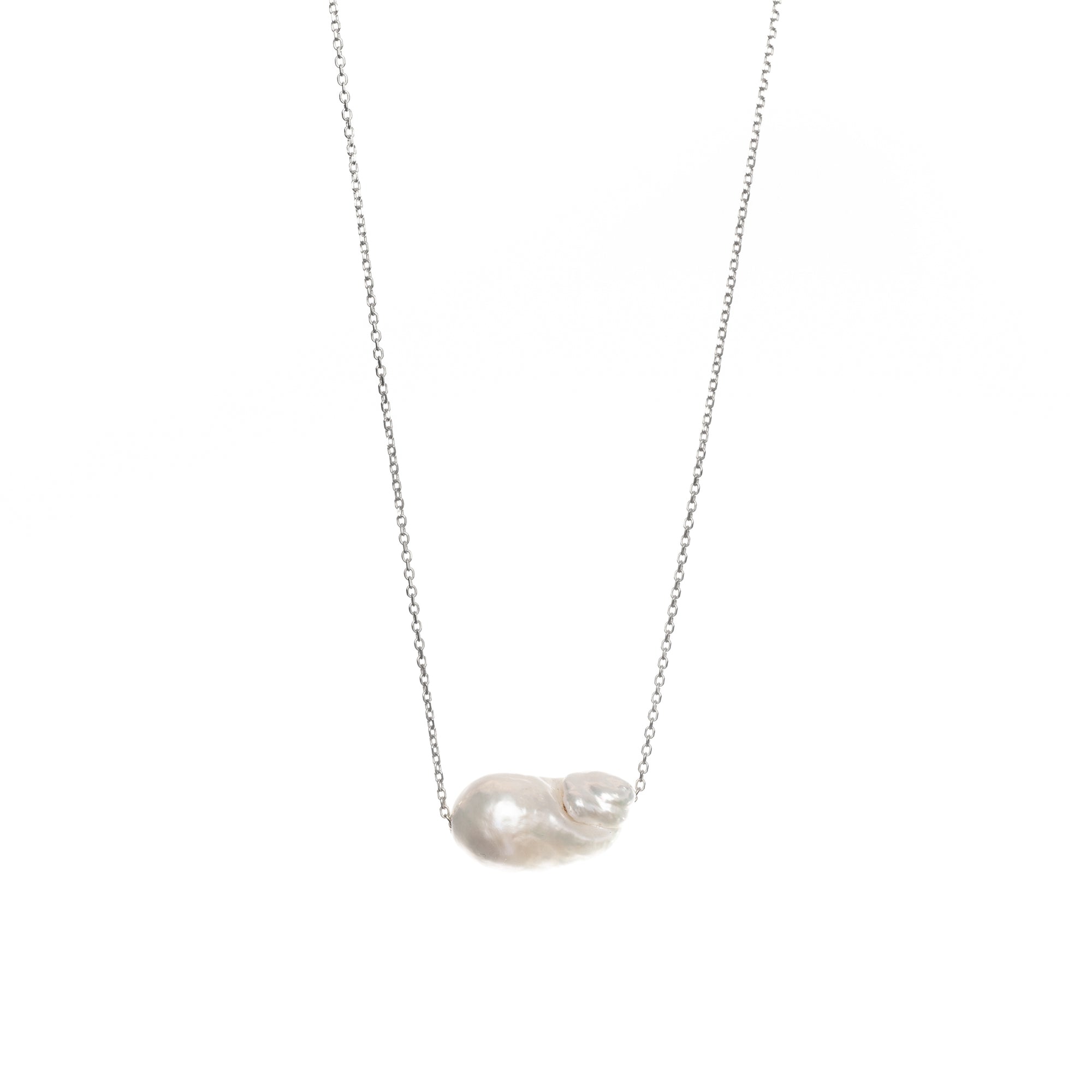 Baroque-shaped freshwater pearl suspended from a delicate white gold chain on a white background.