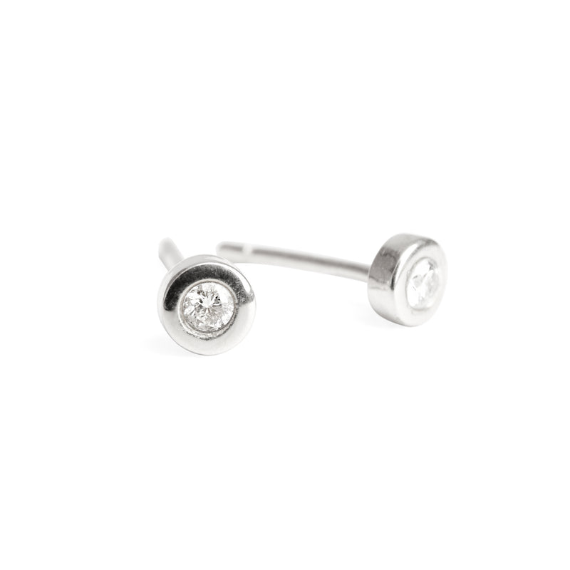 A pair of 14k white gold stud earrings with diamonds set in them.
