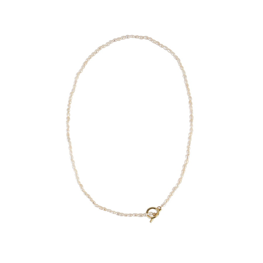 Delicate freshwater pearl necklace featuring organically shaped pearls and a minimalist yellow gold clasp against white background.