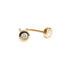 A pair of 14k yellow gold stud earrings with a single white diamond on each, set against a plain background.