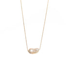 Unique baroque-shaped freshwater pearl suspended from a delicate yellow gold chain. 
