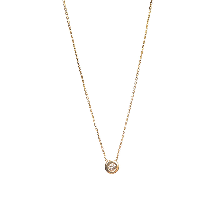 A simple gold choker necklace with a small diamond pendant in the center, presented on a white background.