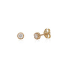 A pair of 14k yellow gold stud earrings with white diamonds attached to the studs.